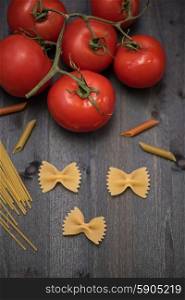 food background . food background on rustic wood with pasta and tomatoes