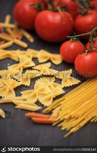 food background . food background on rustic wood with pasta and tomatoes