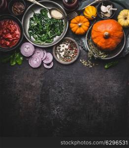 Food background for healthy vegetarian cooking ingredients for tasty pumpkin dishes recipes in bowls : tomato sauces, spinach, sliced onion, pumpkin seeds, top view, banner. Clean seasonal eating