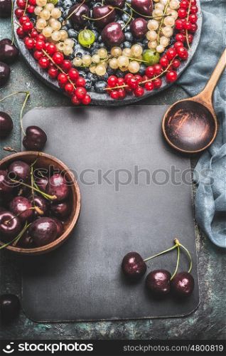 Food background for recipes with various berries, cooking spoon, bowls and napkin , top view frame
