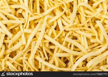 food background - many durum wheat semolina homemade egg pasta taglierini