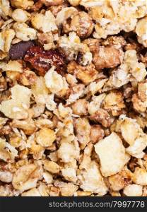 food background - muesli with dried fruit, nuts and chocolate close up