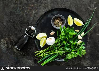 food background of culinary ingredients with blank space for a text on a dark metal table top