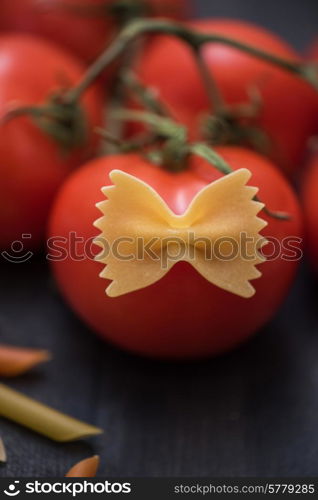 food background on rustic wood with pasta and tomatoes. food background