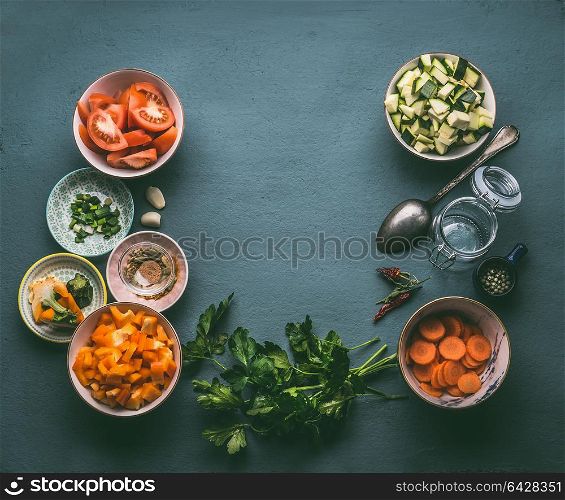 Food background with fresh diced vegetables , cooking spoon and glass jar, top view, frame. Healthy vegetarian food and cooking concept. Homemade lunch in jar making ingredients.