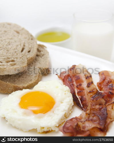 food background with fresh egg and crispy bacon