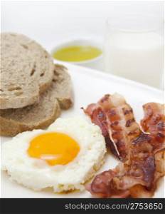 food background with fresh egg and crispy bacon