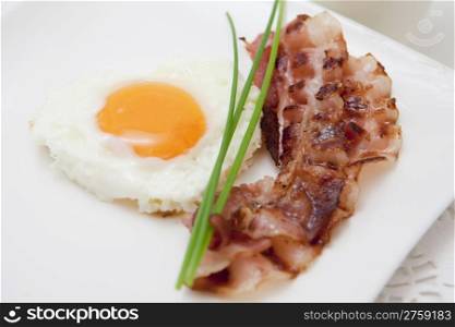 food background with fresh egg and crispy bacon