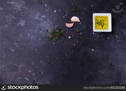 Food background with spices. Food background - olive oil and pepper on dark table background