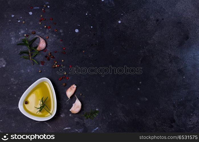 Food background with spices. Food background - olive oil and spices on black background
