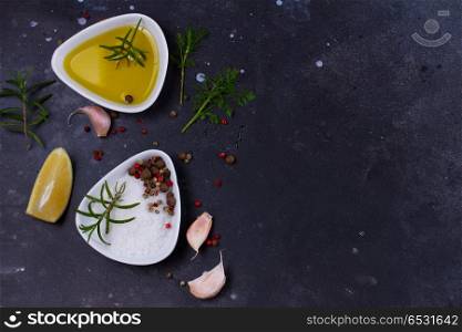 Food background with spices. Food background - olive oil and spices on black stone background
