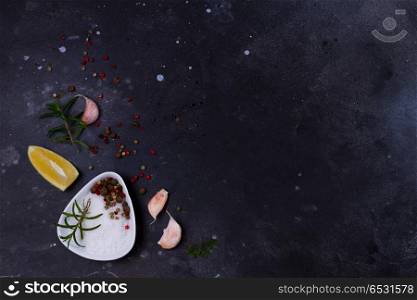 Food background with spices. Food background - salt and peppers spices on black background