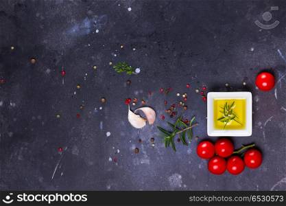 Food background with spices. Food background - spices, olive oil and tomatoes on dark background