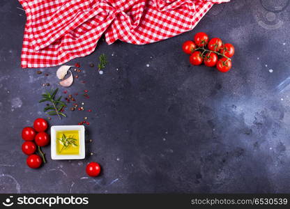 Food background with spices. Food background - spices, olive oil, meat fork and tomatoes on black background