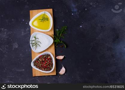 Food background with spices. Food background - spices with olive oil on black background