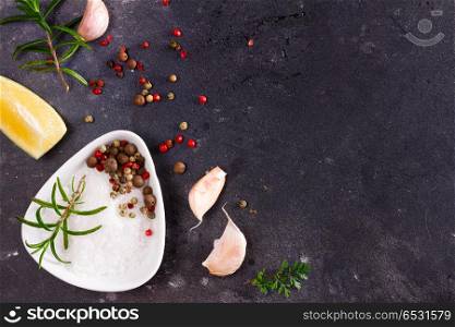 Food background with spices. Food flat lay background - salt and peppers spices on black background