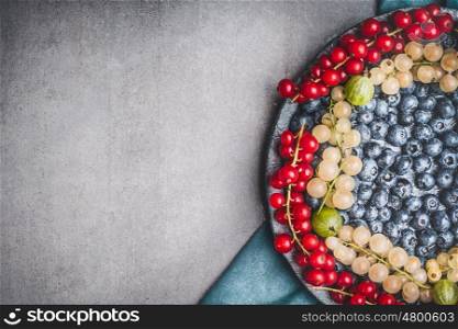 Food background with various colorful berries, top view, place for text