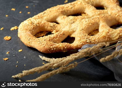 food, baking and cooking concept - close up of cheese bread with reeds on kitchen table. close up of cheese bread on kitchen table