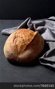 food, baking and cooking concept - homemade craft bread on table. homemade craft bread on table