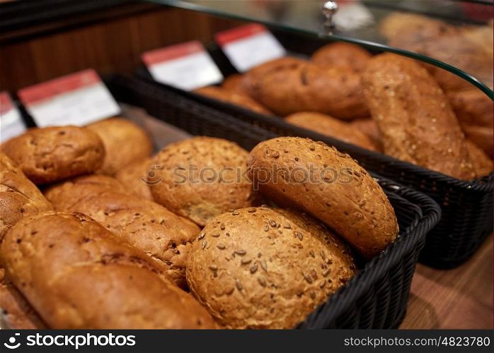 food, baking and sale concept - close up of bread at bakery or grocery store