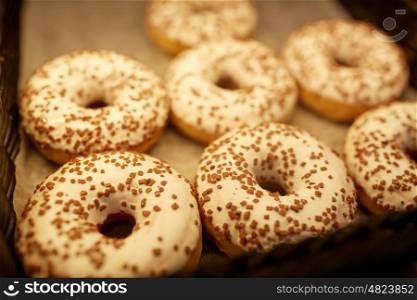 food, baking and sale concept - close up of donuts at bakery or grocery store