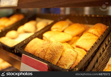 food, baking and sale concept - close up of pies at bakery or grocery store