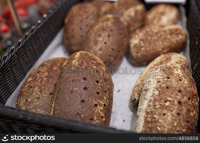 food, baking and sale concept - close up of rye bread at bakery or grocery store
