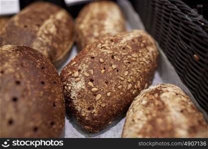 food, baking and sale concept - close up of rye bread at bakery or grocery store. close up of rye bread at bakery or grocery store