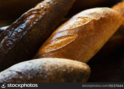 food, baking, junk-food and unhealthy eating concept - close up of different bread loafs. close up of bread loafs