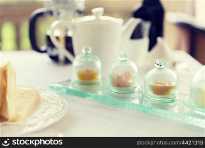 food, breakfast and eating concept - close up of tea time set with jam on table at restaurant
