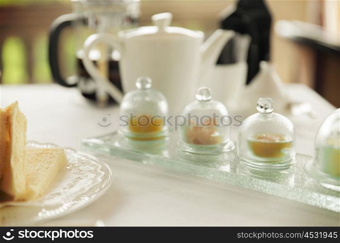 food, breakfast and eating concept - close up of tea time set with jam on table at restaurant