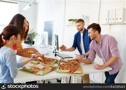 food, business lunch and people concept - happy creative team eating pizza at office. happy business team eating pizza at office