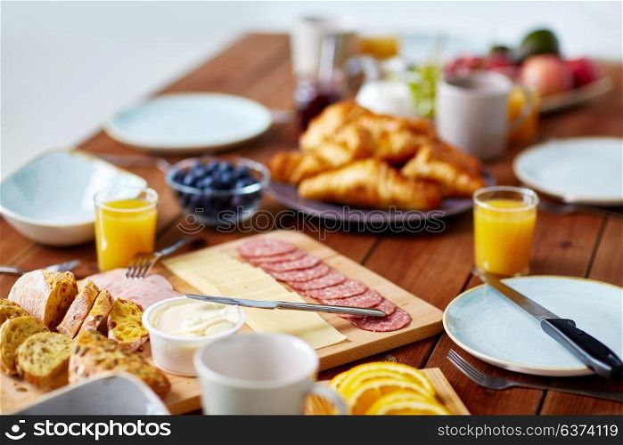food, catering and eating concept - served wooden table at breakfast. food on served wooden table at breakfast