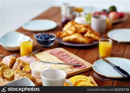 food, catering and eating concept - served wooden table at breakfast. food on served wooden table at breakfast