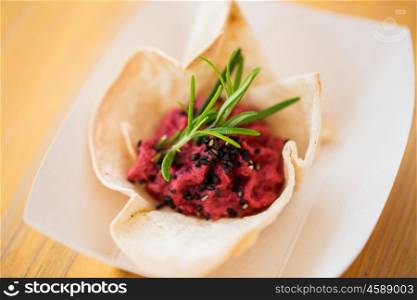 food, catering, cooking and eating concept - close up of dough cornet with beetroot filling
