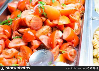 food, catering, eating and cooking concept - close up of tomato salad in metallic container