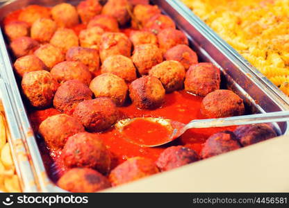 food, catering, self-service and eating concept - close up of meatballs and other dishes on metallic tray