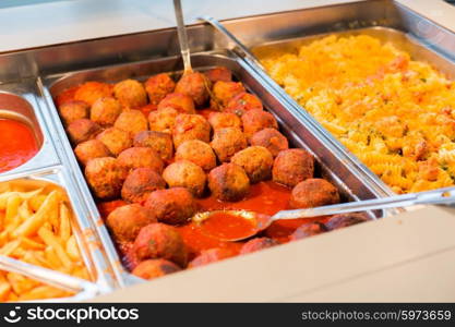 food, catering, self-service and eating concept - close up of meatballs and other dishes on metallic tray
