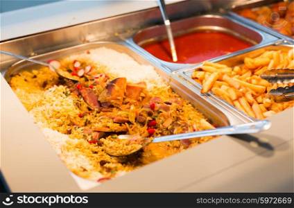 food, catering, self-service and eating concept - close up of rice pilaf and other dishes on metallic tray