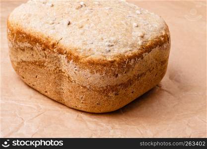Food. Closeup freshly baked loaf of bread on baking paper