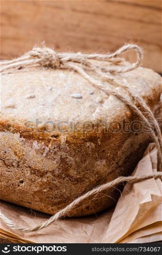 Food. Closeup freshly baked loaf of bread on baking paper