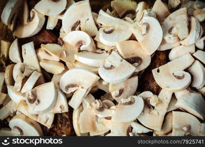 Food. Closeup of roasted chicken meat with champignons mushrooms as background. Cooking and traditional cuisine.