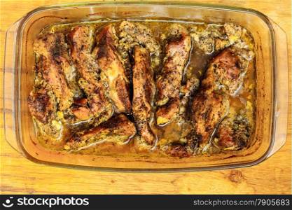 Food. Closeup of roasted chicken meat with spices and herbs in glass dish. Cooking and traditional cuisine.