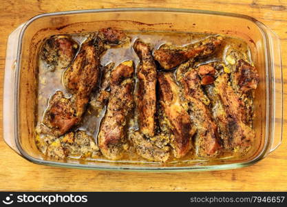 Food. Closeup of roasted chicken meat with spices and herbs in glass dish. Cooking and traditional cuisine.