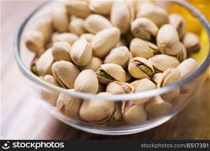 food concept - close up of pistachio nuts in glass bowl. close up of pistachio nuts in glass bowl. close up of pistachio nuts in glass bowl