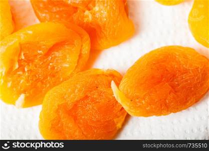 Food concept. Detailed closeup of dried apricots in different shades of orange. Detailed closeup of orange dried apricots