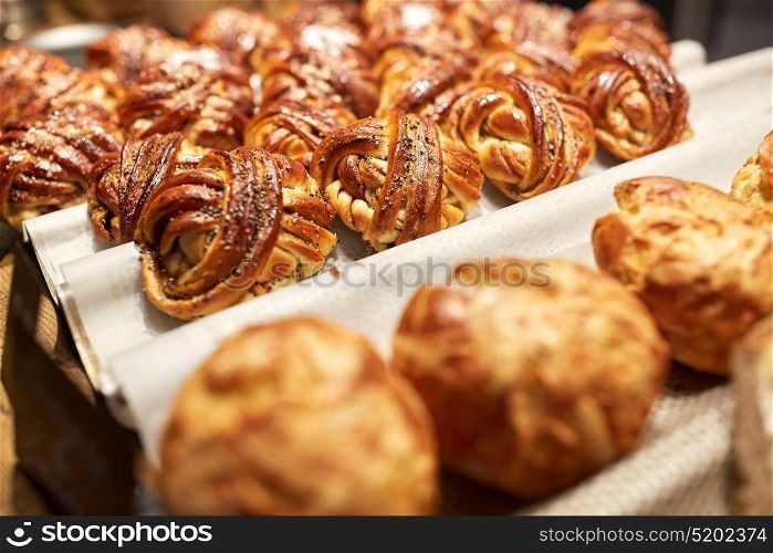 food, cooking and baking concept - close up of buns or pies at bakery. close up of buns or pies at bakery