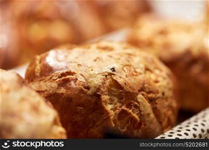food, cooking and baking concept - close up of yeast bread, bun or pie at bakery. close up of yeast bread, bun or pie at bakery