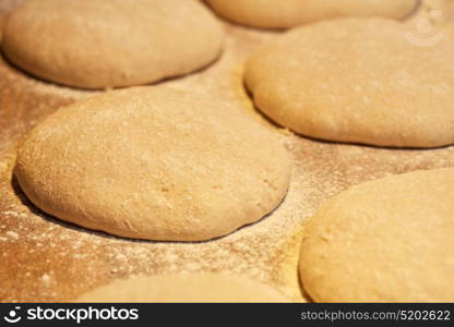 food, cooking and baking concept - close up of yeast bread dough rising at bakery. close up of yeast bread dough at bakery