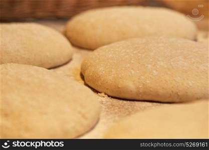 food, cooking and baking concept - close up of yeast bread dough rising at bakery. close up of yeast bread dough at bakery